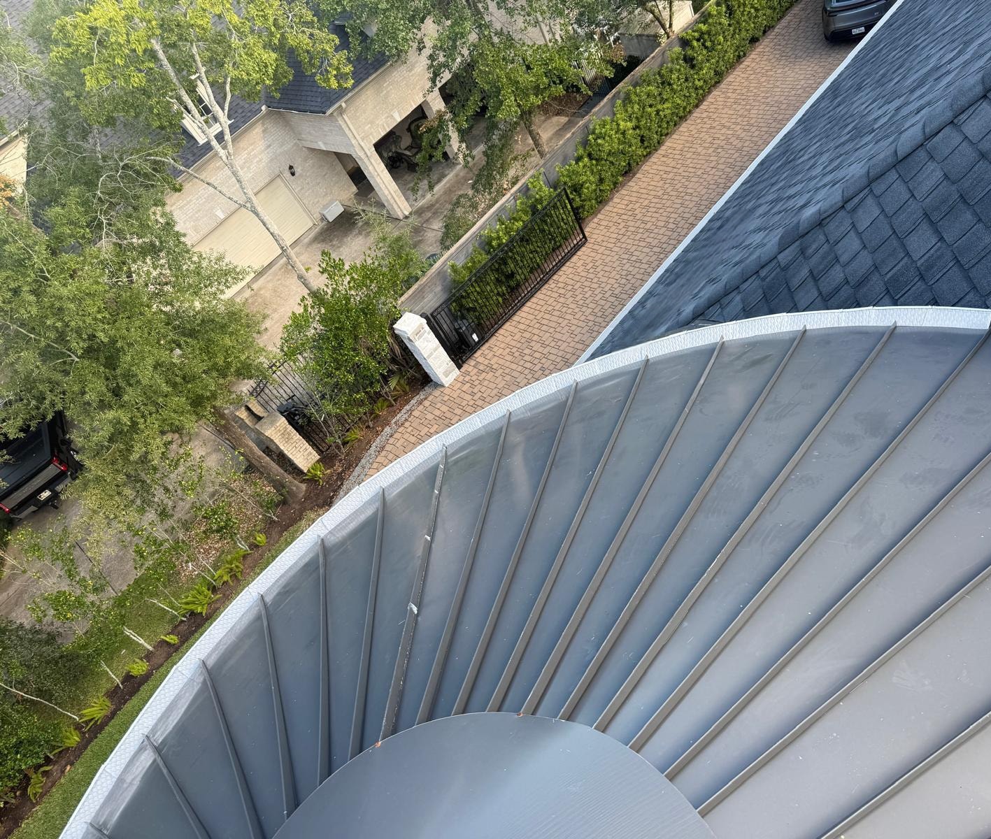 Aerial view of curved seamless gutter installation — Houston TX