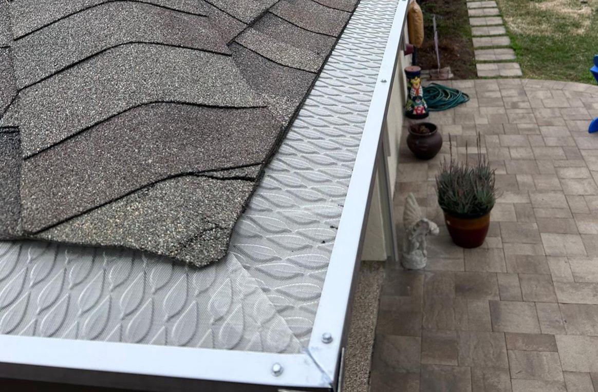 FloMaster Pro gutter guard close-up over paver patio — Houston TX